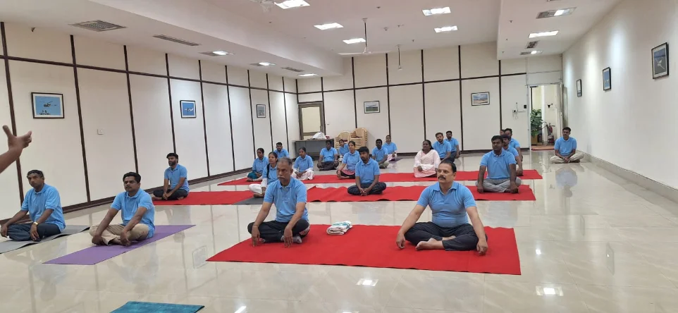 Students practising cobra pose together during a morning class